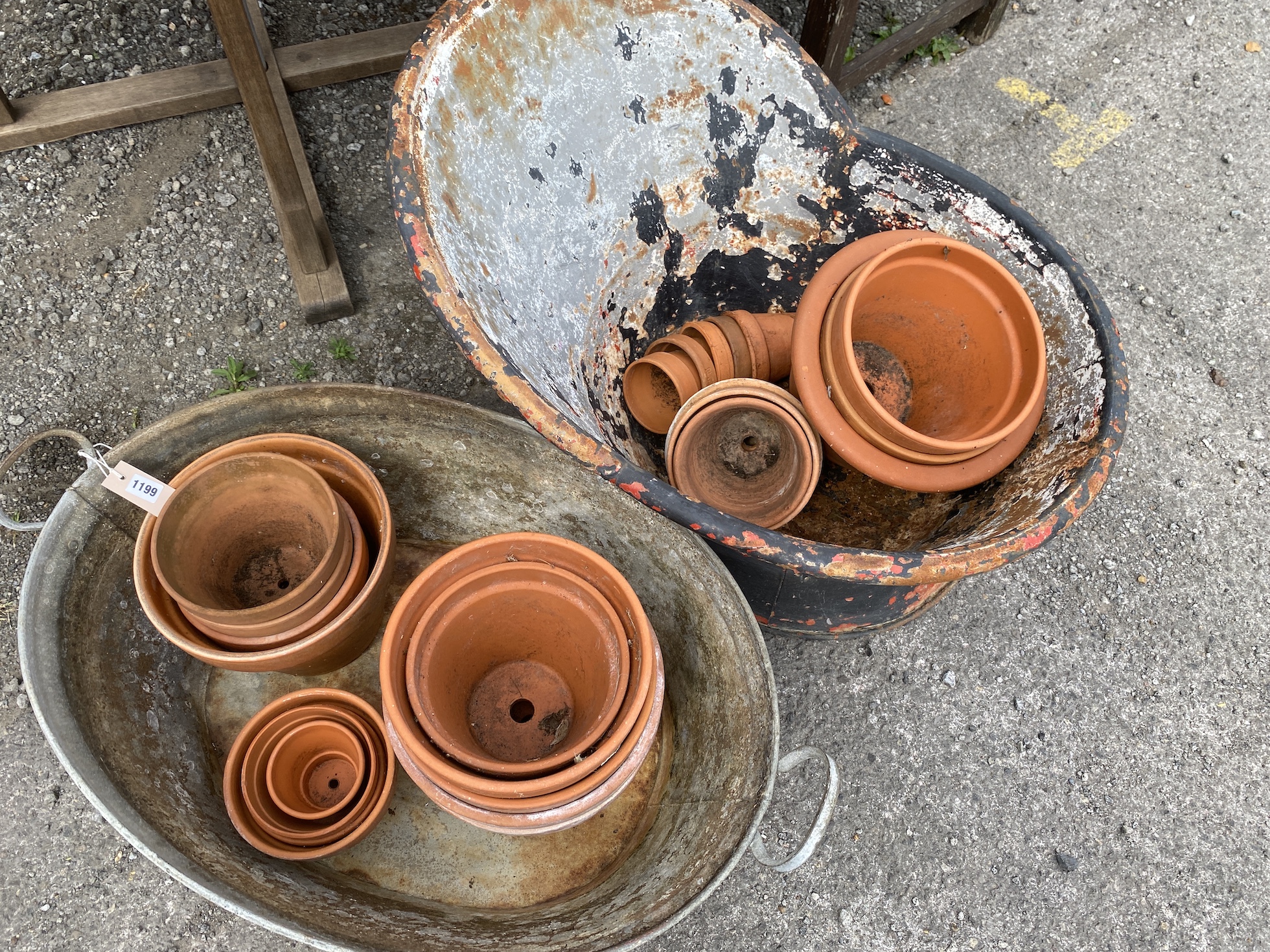A vintage galvanised hip bath, height 54cm, an oval galvanised two handled grain trough and a quantity of terracotta pots